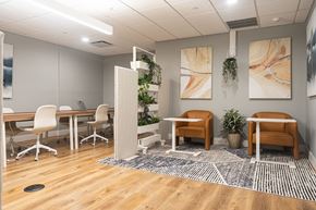 Troy apartment for rent - A modern office space with wooden floors and furniture.