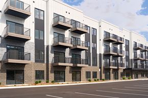 Troy apartment for rent - Apartment building with balconies and black railings.