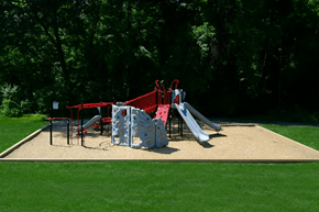 Comstock Park apartment for rent - A playground with a slide, swings, and a climbing wall.