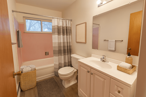 Lansing apartment for rent - A bathroom with a toilet, sink, and bathtub.