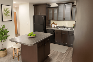 East Lansing apartment for rent - A kitchen with brown cabinets and a black fridge.