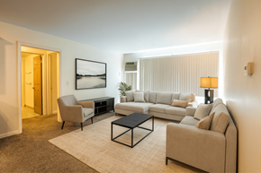 East Lansing apartment for rent - A living room with a couch, chair, and coffee table.