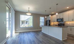 Holt apartment for rent - A kitchen with white cabinets and a large island.