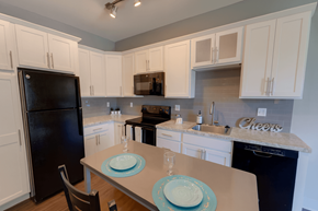 East Lansing townhouse for rent - A kitchen with a table set for two with a plate and a glass.