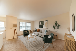 East Lansing townhouse for rent - A living room with a couch, chair, and a table.