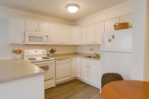 East Lansing apartment for rent - A kitchen with white cabinets and appliances.