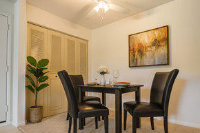 Okemos apartment for rent - A dining room with a table set for two and a painting on the wall.