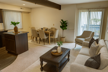 East Lansing apartment for rent - A living room with a brown coffee table and a grey couch.