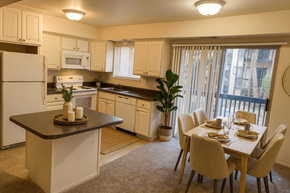 East Lansing apartment for rent - A kitchen with a dining table and chairs.