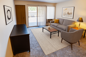 East Lansing apartment for rent - A living room with a grey couch, a brown chair, a brown coffee table, and a brown cabinet.