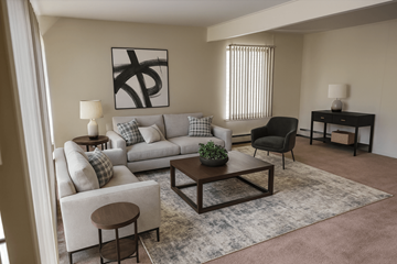 East Lansing apartment for rent - A living room with a grey couch, a black chair, a wooden coffee table, and a painting on the wall.