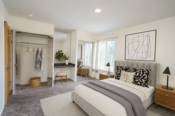 East Lansing apartment for rent - A bedroom with a large bed and a wardrobe.