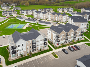 Hudsonville apartment for rent - A large apartment complex with a pool and tennis court.