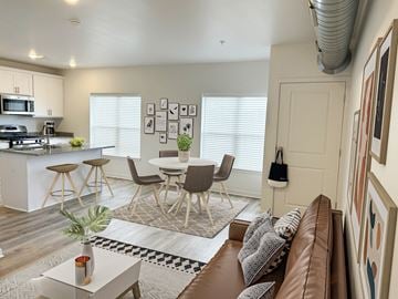 Hudsonville apartment for rent - an open living room and kitchen with a table and chairs