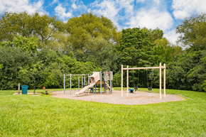 Ann Arbor apartment for rent - A playground with a slide and swings in a park.