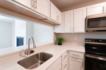 Kentwood apartment for rent - A kitchen with white cabinets and a stainless steel sink.