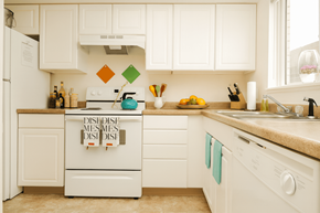 Lansing townhouse for rent - A kitchen with white appliances and a tile backsplash.