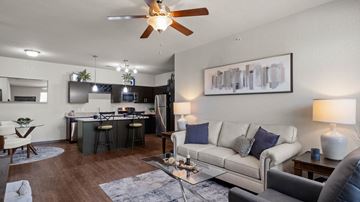 Grand Rapids apartment for rent - A modern living room with a bar area and a kitchen in the background.