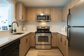Ann Arbor apartment for rent - A modern kitchen with wooden cabinets and stainless steel appliances.