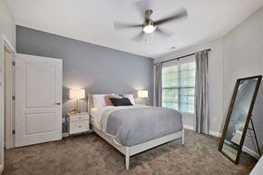 Ada apartment for rent - a bedroom with a bed and a ceiling fan