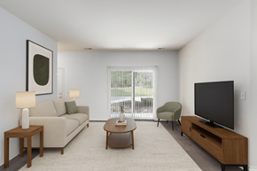 Lansing apartment for rent - A living room with a couch, chair, and television.