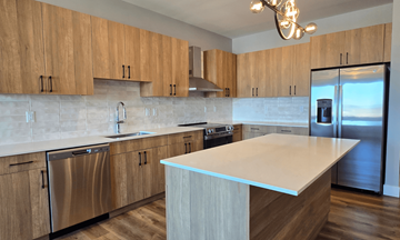 Troy apartment for rent - A kitchen with wooden cabinets and a white island.