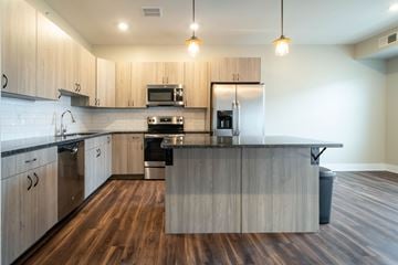Grand Rapids apartment for rent - A modern kitchen with wooden cabinets and a central island.