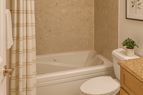 East Lansing apartment for rent - A bathroom with a toilet, a bathtub, and a plant.