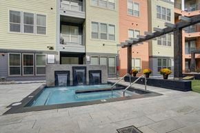 Lansing apartment for rent - Resident courtyard with grills, putting green and hot tub | Vista at the Heights Apartments in Lansing MI