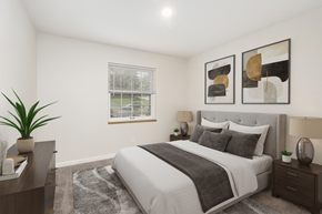 Grand Rapids apartment for rent - A bedroom with a large bed, a nightstand, and a plant.