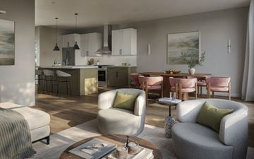 Okemos triplex for rent - A modern living room with a grey sofa and a coffee table.