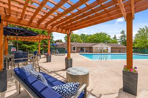 Westland apartment for rent - A wooden pergola over a pool area with a blue lounger.