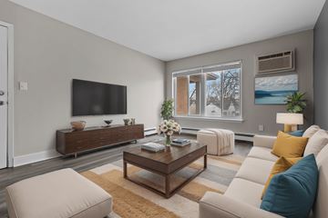 Madison Heights apartment for rent - A living room with a brown coffee table and a white couch.