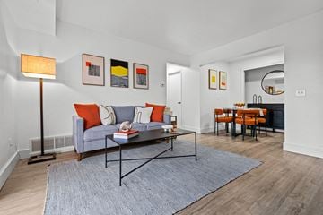 Clinton Twp apartment for rent - a living room with a couch and a table