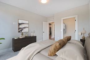 Troy apartment for rent - A bedroom with a large bed and a wooden dresser.