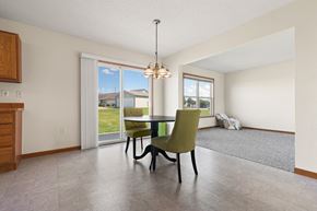 Freeland triplex for rent - a dining room with a table and chairs and a window