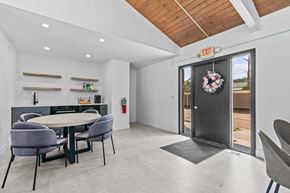 Allen Park apartment for rent - a dining area with a table and chairs and a door with a wreath on it