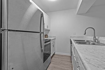 Lansing apartment for rent - the kitchen of an apartment with stainless steel appliances and marble counter tops