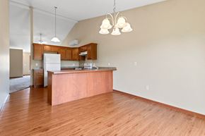 Midland townhouse for rent - an empty living room and kitchen with wood flooring