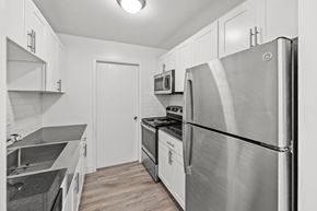 Southfield apartment for rent - A modern kitchen with a stainless steel refrigerator and a microwave above the stove.