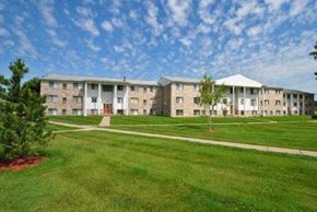 Harrison Twp apartment for rent - a grassy area with several apartment buildings in the background