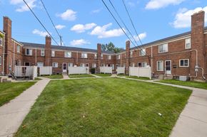 Oak Park townhouse for rent - an image of a large brick building with a yard in front