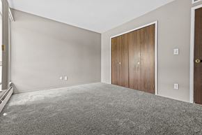 Roseville townhouse for rent - a bedroom with grey carpet and a wooden door