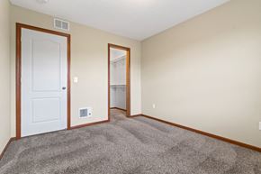 Midland townhouse for rent - a bedroom with carpet and a door to a closet