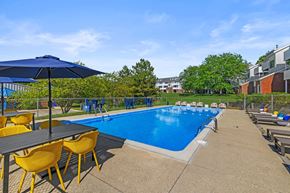 Grand Rapids apartment for rent - A pool area with a table and chairs.