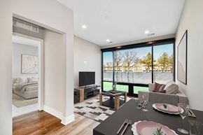 Troy apartment for rent - A modern dining room with a black table set for two.