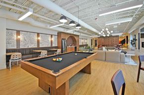 Troy apartment for rent - A pool table is in the middle of a room with a couch and chairs.