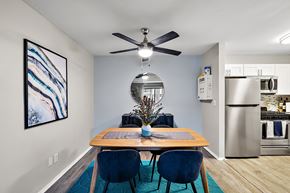 Ann Arbor townhouse for rent - A dining room with a wooden table and blue chairs.