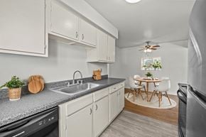 Madison Heights apartment for rent - A kitchen with white cabinets and a black dishwasher.