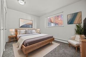 Madison Heights apartment for rent - A bedroom with a large bed and a painting on the wall.